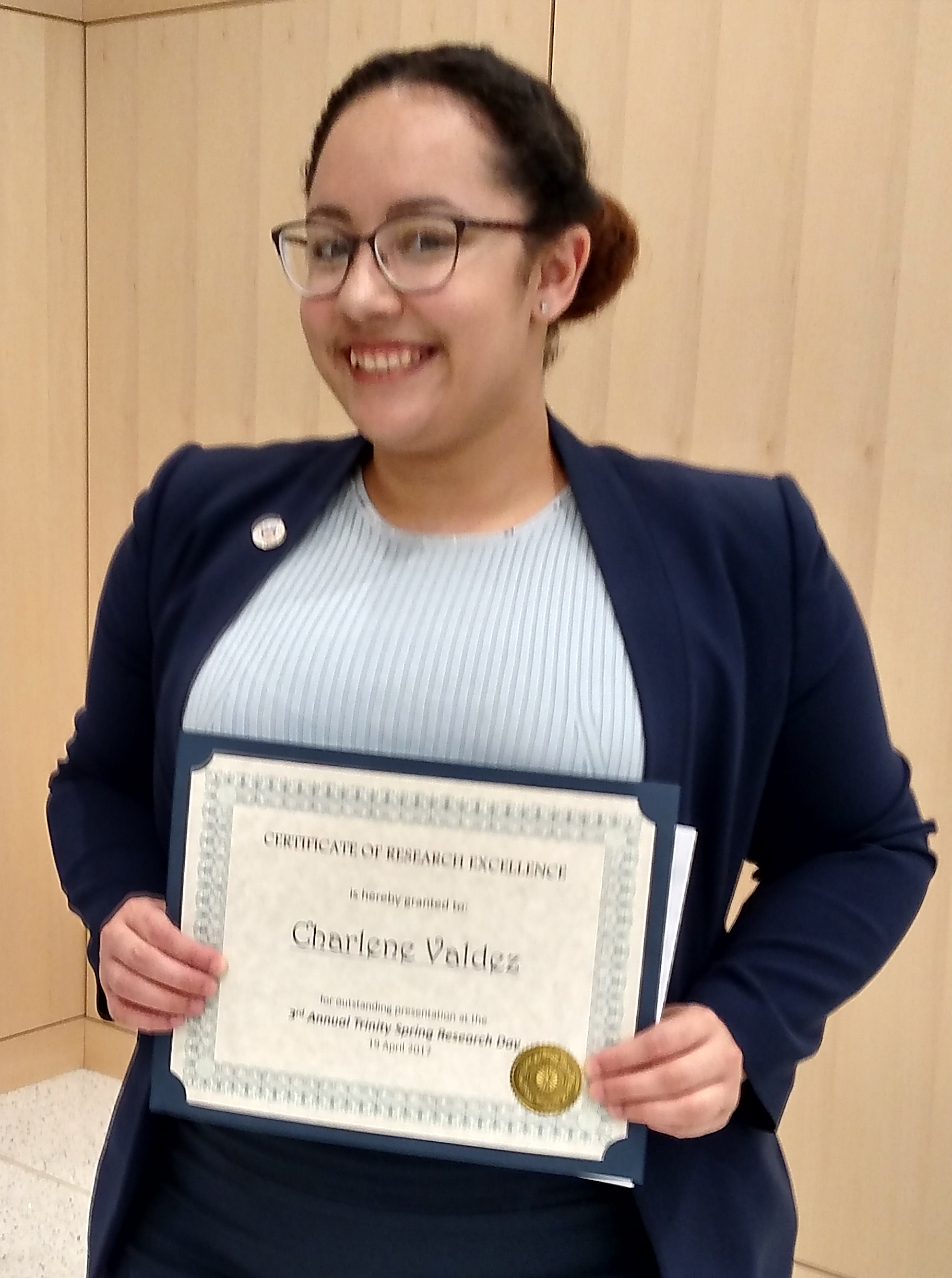 Charlene Valdez displays her certificate