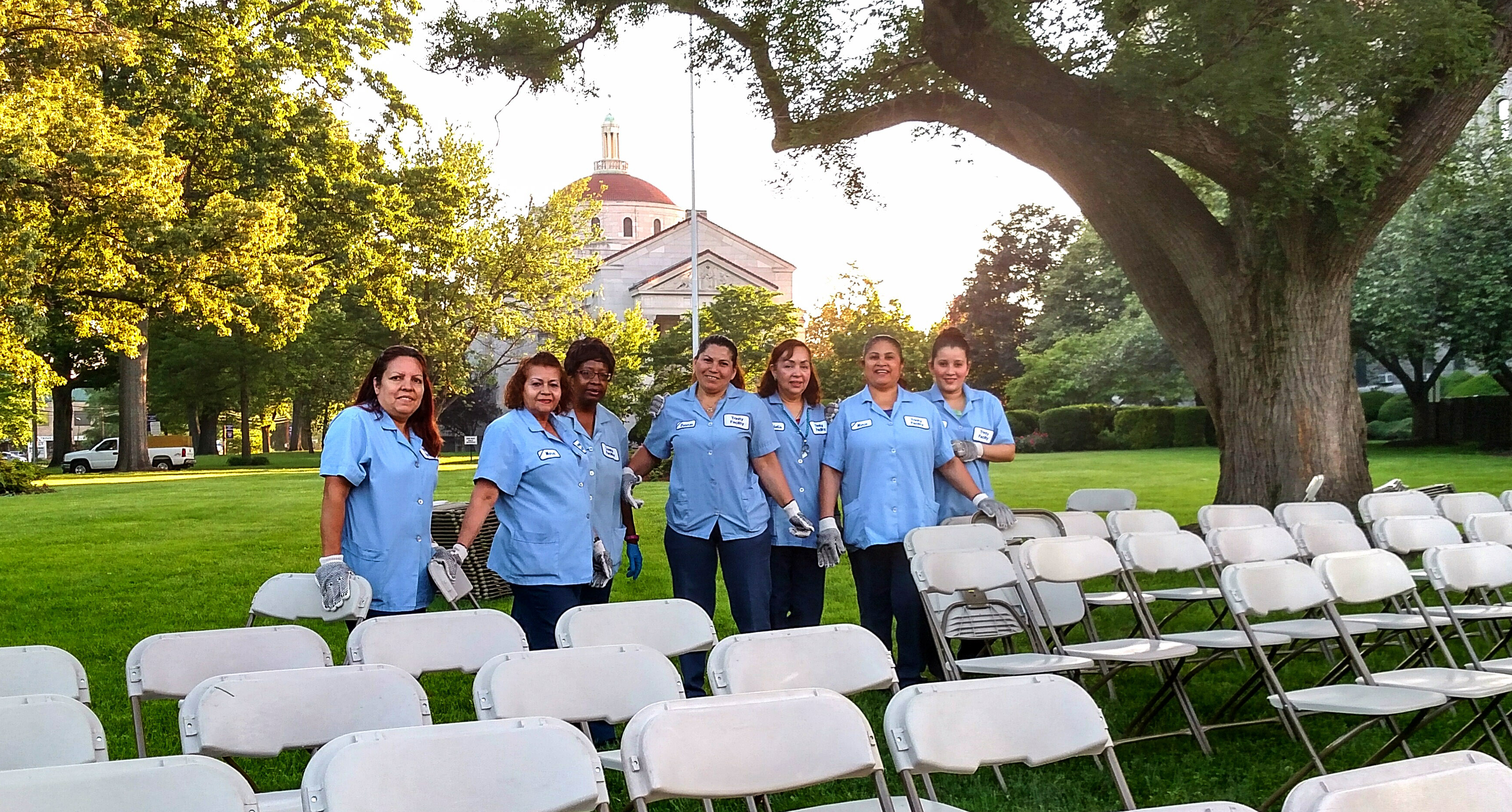 Housekeeping team sets up chairs on the lawn